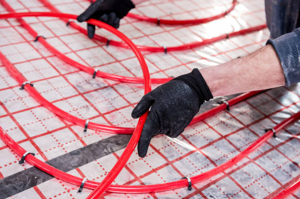 istock Pipefitter install system of underfloor heating system at home 1317094020