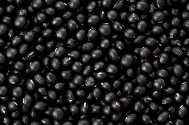 istock Raw  black beans background, close-up, 1317094235