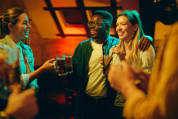 istock Young cheerful adult toasting while drinking during the night out in a pub. 1317095049