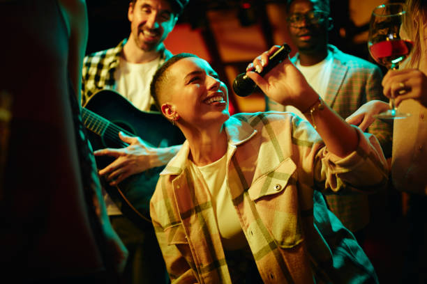 istock Young Black woman having fun while singing on a party at the bar. 1317095084