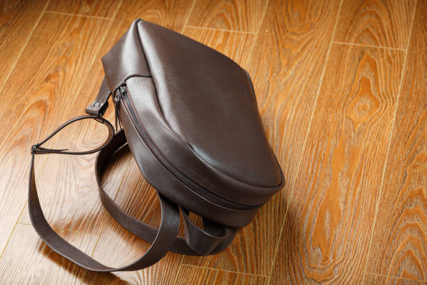 istock Backpack made of brown genuine leather on a wooden background. 1317096447