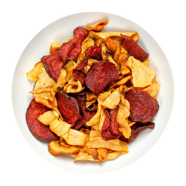 istock Mixed root vegetable crisps, sliced and fried root veg, in a white bowl 1317098670