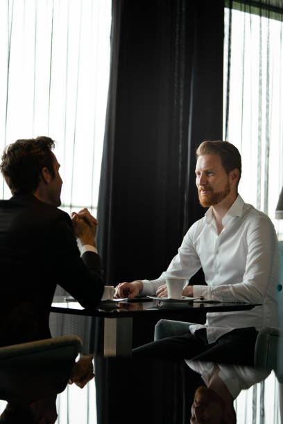 istock Two business people sitting at coffee shop discussing project 1317102729