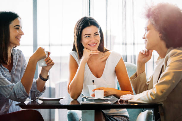 istock Group of people enjoyed talking and drinking coffee together in cafe 1317102741
