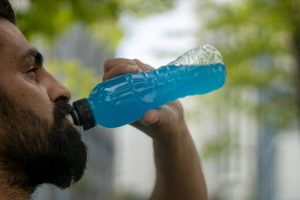 istock Shot of a young man drinking from his water bottle while out for a 1317104250