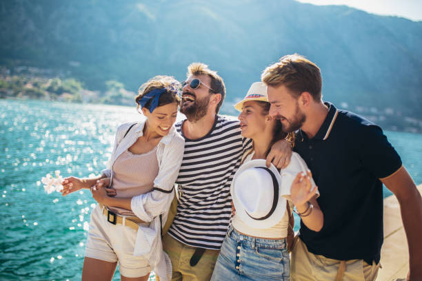 istock Group of friends walking along a beach at summertime. 1317104484