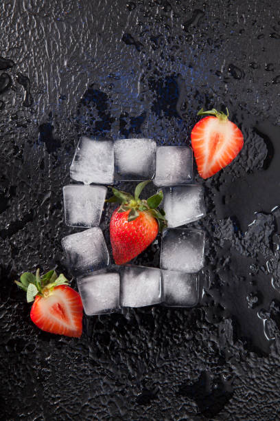 istock Fresh red strawberries with ice cubes on dark textured background 1317105186