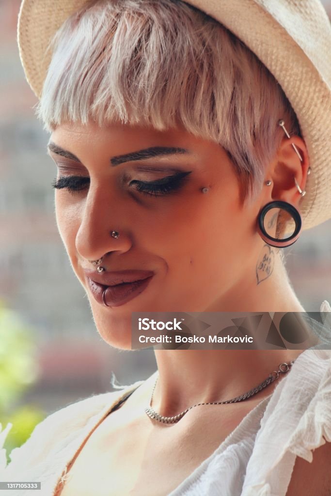 Modern Portrait of pierced hipster looking beautiful girl model Pierced Stock Photo
