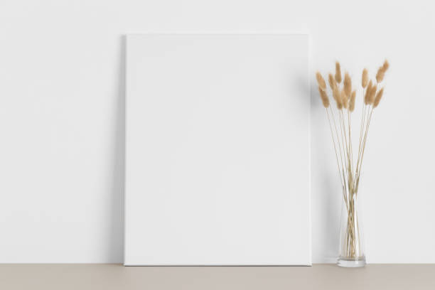 istock White canvas mockup with lagurus on the beige table. 1317106727