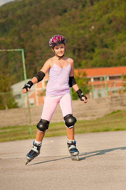 istock Cute young girl rollerskates on a playground 131710974