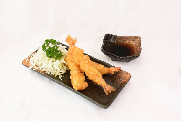 Various Sushi Set in black plate, selective focus at Burned Salmon Sushi topped with shrimp roe in the center, isolated on white background. Usable for Japanese Restaurant as Picture menu Tempura Prawns stock pictures, royalty-free photos & images