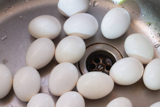 istock Wet chicken white eggs in the kitchen sink washed with water 1317117002
