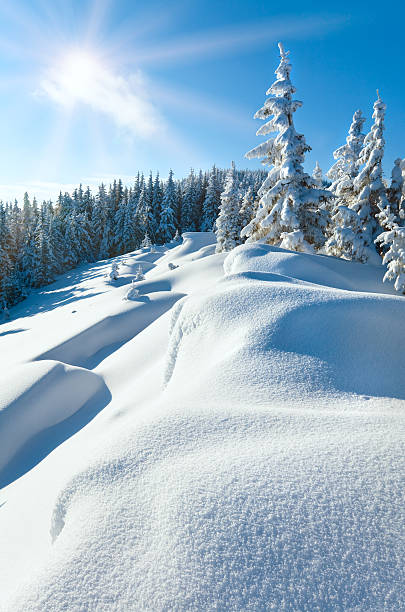 istock Snowdrifts on winter snow covered mountainside and sun 131711748