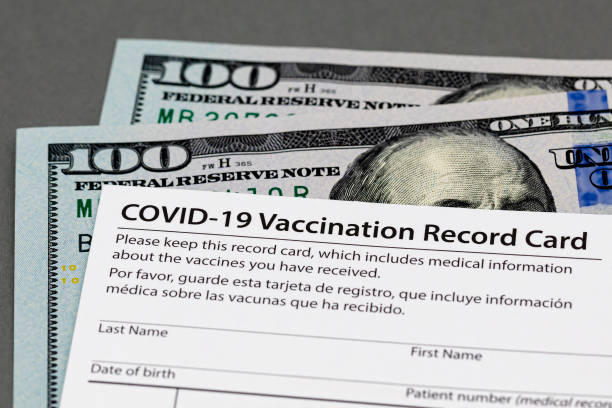 Covid-19 vaccination record card and cash money. Fake, vaccine card fraud and forgery concept background, no people synthetic identity theft stock pictures, royalty-free photos & images