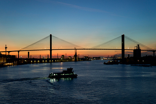 Navigating through Savannah River during sunset, close to the Port of Savannah, Georgia.