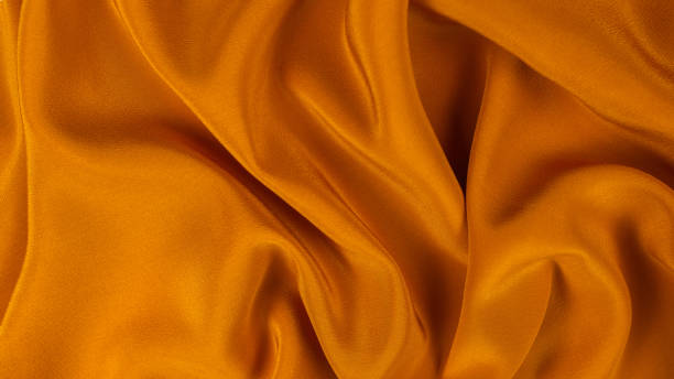 istock Golden silk or satin luxury fabric texture can use as abstract background. 1317125453