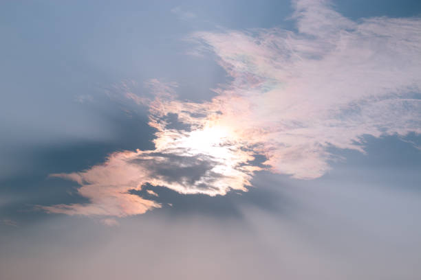istock strong light rays from sun through cloud in a very bright sunny day 1317128694