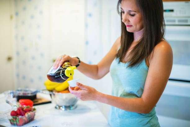 Millennial Female in Kitchen Preparing Meal Using Plastic Containers Photo Series