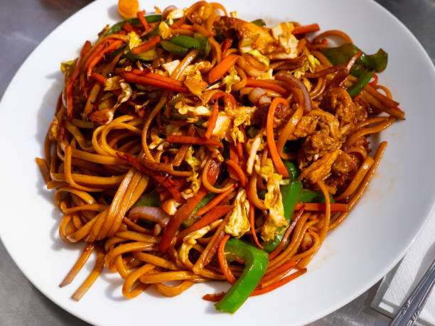 istock Fried noodle dish with onion, pepper, carrot, meat and egg 1317129980