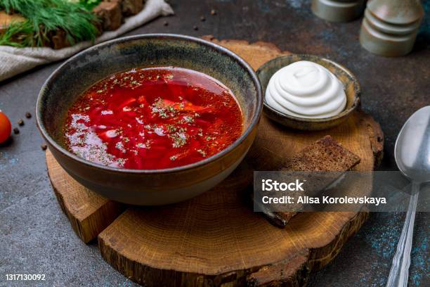 Borscht With Sour Cream On Beautiful Board On Dark Concrete Table Stock Photo - Download Image Now