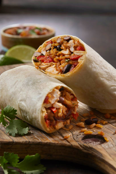 Mexican Rice and Chicken Burrito Mexican Rice and Chicken Burrito with Black Beans, Roast Peppers and Fresh Cilantro burrito stock pictures, royalty-free photos & images