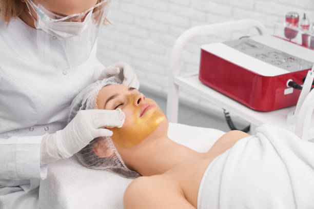 istock Woman lying in beautician and doing procedure for face. 1317132464