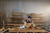 istock Hardworking carpenter polishing wood using abrasive paper 1317132471