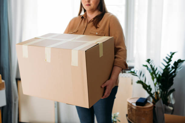 istock Ready to Move out: Anonymous Caucasian Plus Size Woman Holding a Cardboard Box 1317133479