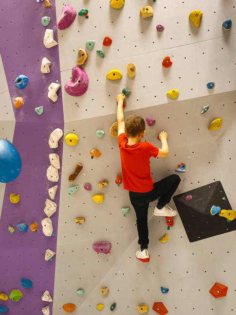 istock Boy is climbing on bouldering wall 1317135808
