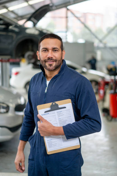 istock Latin American mechanic working at a car garage 1317137066
