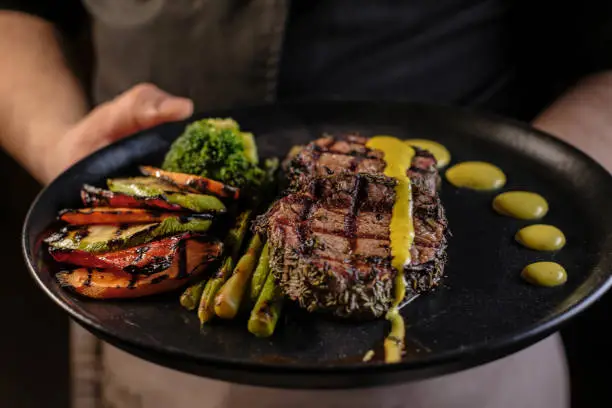 Grilled beef steak with asparagus and vegetables on plate