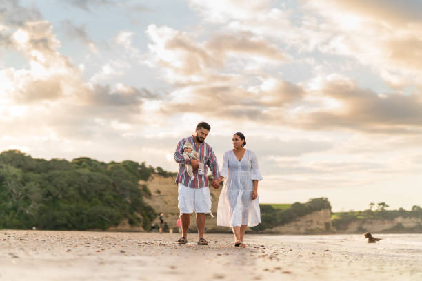 istock Couple with one child making fun outdoor with background. 1317142429