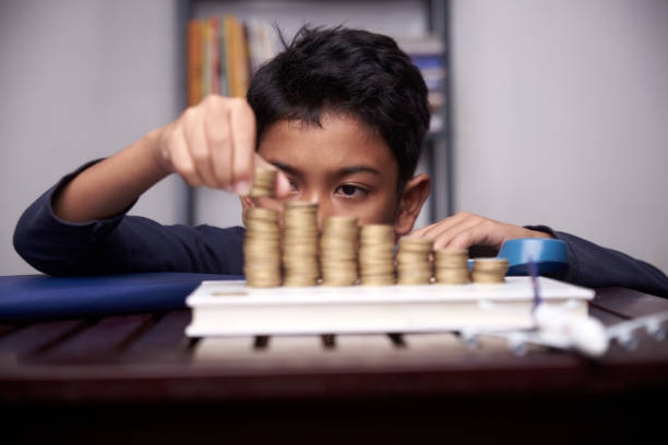 Boys making stucks of coins stock photo