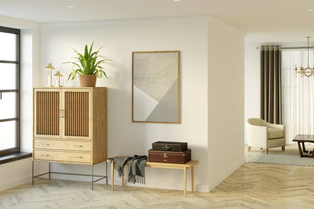 istock A bright hall with a window, a vertical poster over a wooden bench with leather suitcases, a flower in a wicker basket on a wooden chest of drawers, a living room in the background. 1317145992