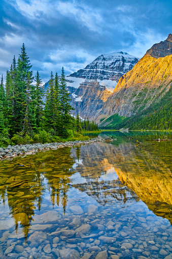 Mount Edith Cavell reflecting in Cavell Lake in Jasper National Park, Canada
