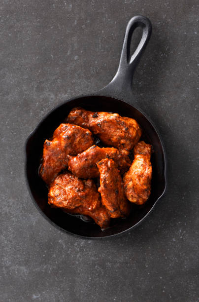 istock Chiken wings in a skillet 1317148250