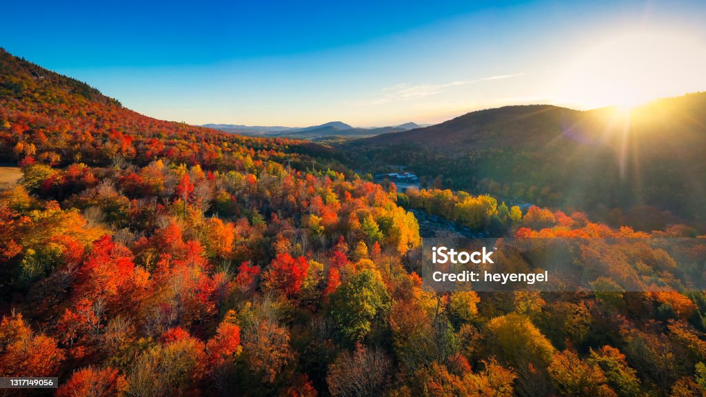 Aerial view of Mountain Forests with Brilliant Fall Colors in Autumn at Sunrise, New England Aerial view of Mountain Forests with Brilliant Fall Colors in Autumn at Sunrise, Adirondacks, New York, New England Autumn Stock Photo