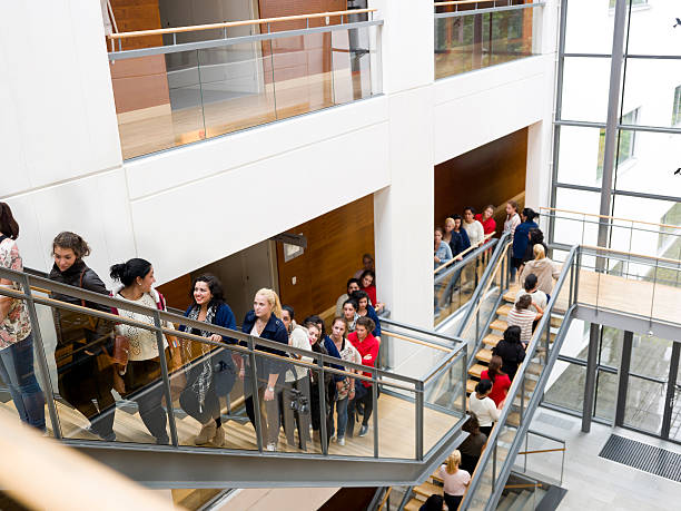 People waiting in line on stairs stock photo
