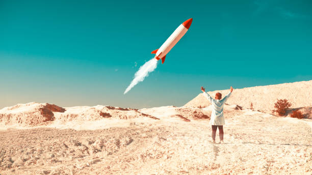 Rocket launch in desert is a success and boy cheers on the ground