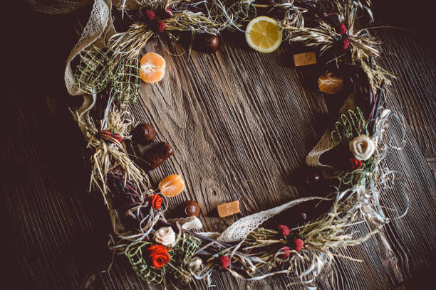 istock Creative Christmas wreath with sweets. An unusual idea for a holiday home decor. Natural interior decor on wooden background. 1317151950