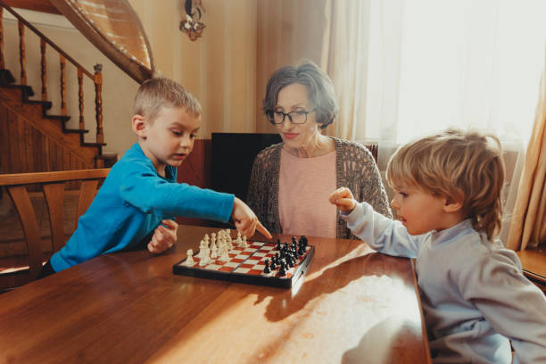 istock Two brothers learning play chess in the room 1317155333