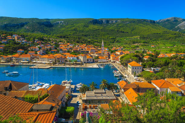 Jelsa waterfront view and harbor with boats, Hvar island, Croatia Fantastic travel and cruise destination. Mediterranean fishing and touristic village with beautiful harbor, Jelsa village, Hvar island, Dalmatia, Croatia, Europe jelsa stock pictures, royalty-free photos & images