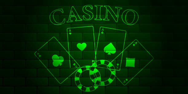 istock Green brick wall with glowing text Casino, playing cards and casino chips. 1317157785