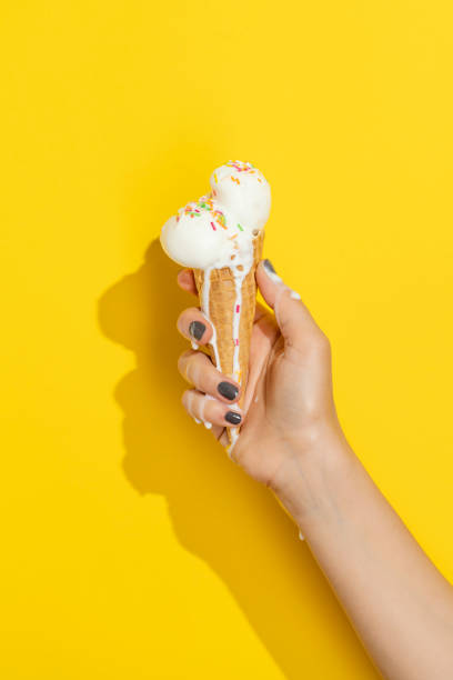 istock Hand holding melting vanilla ice cream 1317161426