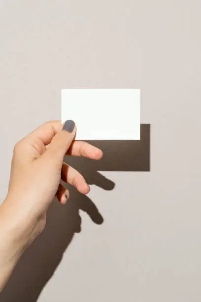 Photo of Hand holding blank business card