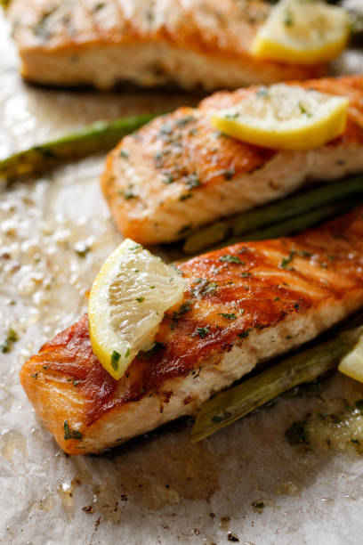 istock Baked salmon with aromatic herbs and lemon on baking paper 1317162763