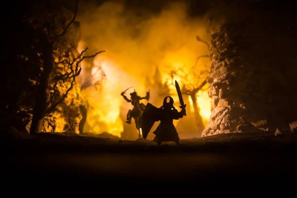 istock Medieval battle scene with cavalry and infantry. Silhouettes of figures as separate objects, fight between warriors on dark toned foggy background with medieval castle. 1317165727