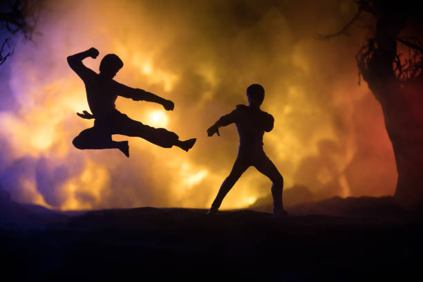 istock Karate athletes fighting scene on boxing ring with red ropes. Character karate. Posing figure artwork decoration. Sport concept. Decorated foggy background with light. Selective focus 1317165753