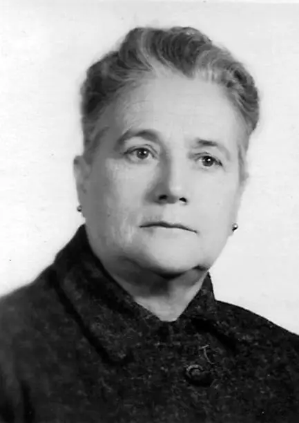 Photo of Image taken in the 60s, headshot of a pensive senior woman looking at the camera