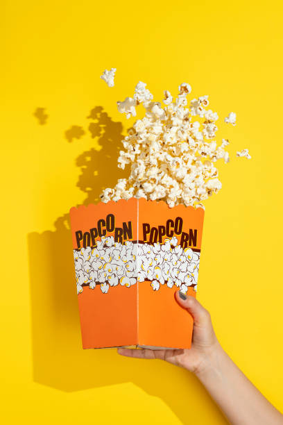 istock Hand holding box of popcorn 1317168458